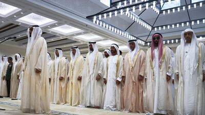 Sheikh Mohammed bin Zayed, centre, prays with, from right, Sheikh Abdullah bin Zayed, UAE Minister of Foreign Affairs and International Cooperation, right, Sheikh Tahnoon bin Zayed , UAE National Security Advisor, Sheikh Saif bin Zayed, UAE Deputy Prime Minister and Minister of Interior, Sheikh Suroor bin Mohammed, Sheikh Hazza bin Zayed, Vice Chairman of the Abu Dhabi Executive Council and Sheikh Mansour bin Zayed. Crown Prince Court - Abu Dhabi