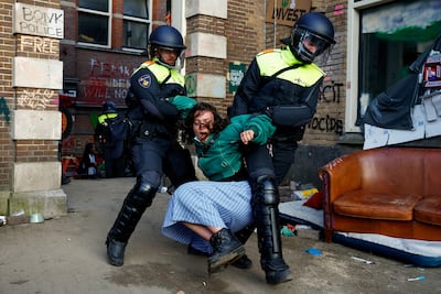 Police officers remove a pro-Palestinian protester outside the University of Amsterdam during a demonstration. Reuters