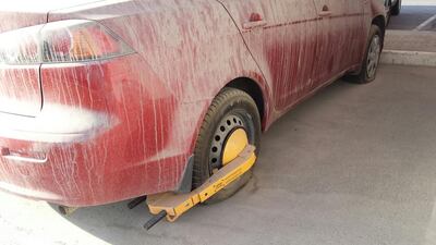 Abandoned vehicles at the Abu Dhabi International Airport’s car parks have been immobilized with wheel clamps. Anwar Ahmad / The National