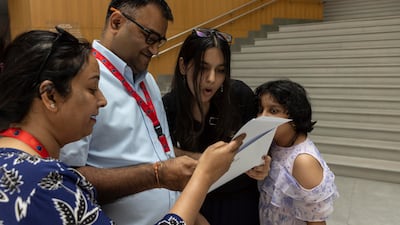Nishna checks her results with her parents Srivatsav and Devpriya at British Arcadian School
