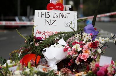Flowers and signs laid at a memorial to victims of the mosque attacks near Linwood mosque in Christchurch. Reuters