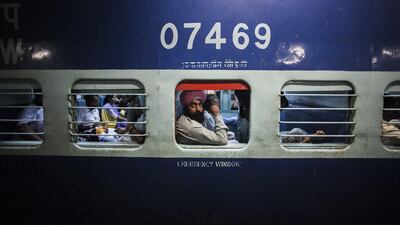 A passenger looks out of a window on the Abohar-Jodhpur Passenger train, known locally as the "Cancer Express", in Bhatinda, Punjab, India. Prashanth Vishwanathan /Bloomberg