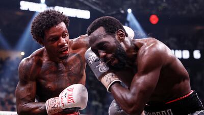 Errol Spence Jr lands a left hook on Terence Crawford. EPA