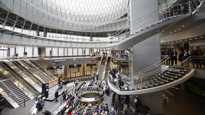People gather for a ceremony at the entrance of the Fulton Center. Mark Lennihan / AP Photo
