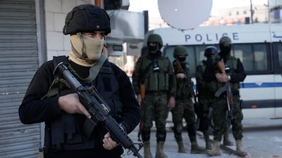 An officer of the Palestinian Authority prepares for a raid on militants in the Jenin refugee camp in the Israeli-occupied West Bank on December 16. AP