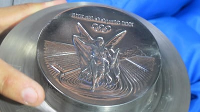 The finished cast is then used as a mould, striking against the blank medal three times, each with 600 tonnes of pressure. Gary Meenaghan for The National