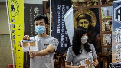 A volunteer holds up a ballot paper during counting in Hong Kong following a vote organised by pro-democracy unions to ask members if they will participate in a city wide strike and if they supported Chinas plans to impose a new national security law in Hong Kong. AFP