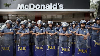 Riot police stand guard in front of a McDonald’s in Manila, Philippines, on November 16, 2015. Philippine security forces are on full alert following the deadly attacks in France as the Asia Pacific Economic Cooperation (APEC) summit continues in the city. Diego Azubel / EPA