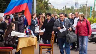 People line up to vote in a referendum in Luhansk in a vote organised by Moscow. AP