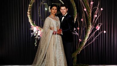 Newlyweds Priyanka Chopra, 36, and Nick Jonas, 26, pose for a photograph during a reception at a hotel in New Delhi on December 4, 2018. Photo: AFP