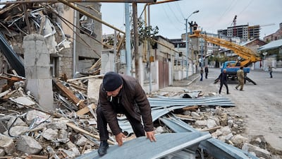 A man rummages through the remains of a home that was damaged by Azeri artillery in Stepanakert, Nagorno-Karabakh. Getty