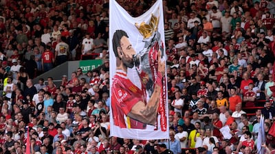 Fans with a banner of Liverpool's Mohamed Salah at Anfield. PA