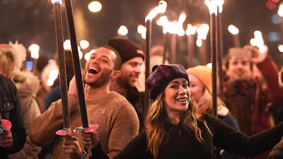 Members of the public take part during the torchlight procession on Edinburgh's Royal Mile for the start of the Hogmanay celebrations. Getty