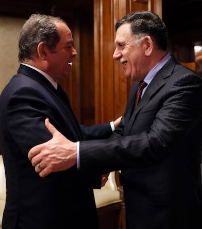 Prime Minister of Libya's Government of National Accord, Fayez Al Sarraj (R) greets Algeria's foreign minister, Sabri Boukadoum, in Tripoli, Libya on February 18, 2020. AFP