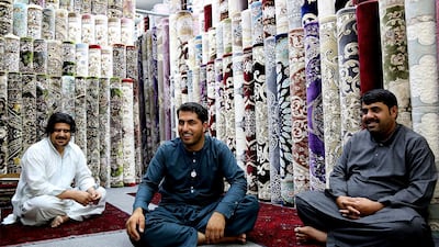 (L-R) Brothers Bilbar Abdul Qader, Moosa Khan Adbul Qadir and Qalandar Khan Mohammad sit in their carpet shop in Abu Dhabi, where Sheikh Mohammed bin Zayed, Crown Prince of Abu Dhabi and Deputy Supreme Commander of the Armed Forces, visited them last week. Satish Kumar for The National