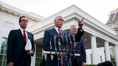 Vice President Mike Pence, with Treasury Secretary Steven Mnuchin, left, and national security adviser Robert O'Brien, speaks to reporters outside the West Wing of the White House, in Washington. The U.S. is calling for an immediate ceasefire in Turkey's strikes against Kurds in Syria, and is sending Pence to lead mediation effort AP Photo