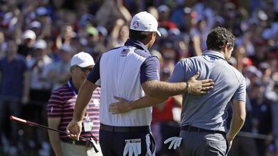 Patrick Reed of the United States and Rory McIlroy of Europe walk off the eighth hole together during the final round of the Ryder Cup on Sunday. David J Phillip / AP Photo / October 2, 2016