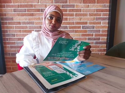 Rima Tuka Armi, an awareness ambassador in Al Kufrah, holds a brochure from the campaign. Photo: Hendia Alashepy