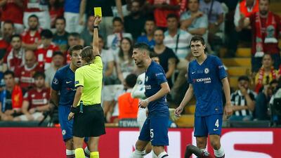 Referee Stephanie Frappart of France gives a yellow card to Chelsea's Cesar Azpilicueta, left. AP Photo