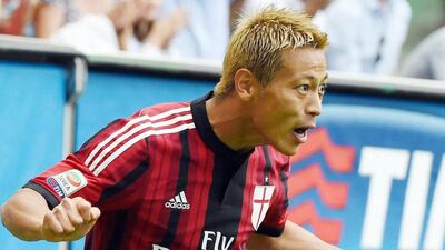 AC Milan's Keisuke Honda celebrates after scoring in a 3-1 win over Lazio on Sunday in Serie A. Daniel Dal Zennaro / EPA / August 31, 2014