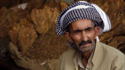 Jargie Hussain, a Kurdish tobacco farmer, waits for customers in his store in Mosul.