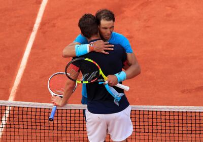 Rafael Nadal embraces Austria's Dominic Thiem after winning their French Open final on Sunday. Gonzalo Fuentes / Reuters