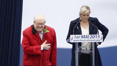 Founder and former president of the Front National Jean-Marie Le Pen, left. gestures toward the audience as his daughter, the curent president, Marine Le Pen, right, waits to make her speech during the traditional May Day rally of France's far-right party on May 1, 2015. Yoan Valat/EPA