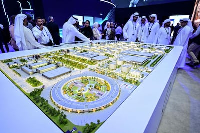 Guests look at a model of Stargate UAE, the largest data centre outside the US, to be based in Abu Dhabi. AFP
