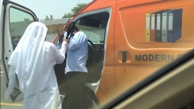 This clip from the YouTube video appears to show the man beating the Asian driver.