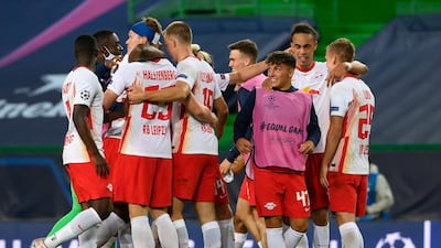 RB Leipzig players celebrate after winning their Champions League quarter-final against Atletico Madrid at the Jose Alvalade stadium. AP