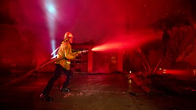 Video captured by local media on Thursday morning showed firefighters still attempting to contain fires in homes that were still standing. Other nearby residences had burnt down. EPA
