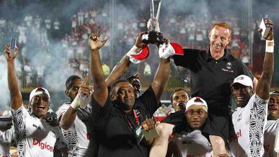 Fiji, then coached by Ben Ryan, second left in black shirt, are crowned Dubai Rugby Sevens winners on November 30, 2013. Jake Badger for The National