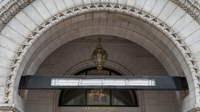 Workers removed the signage of the Trump Hotel in May 2022 after it was sold to a Miami-based investor fund. AP