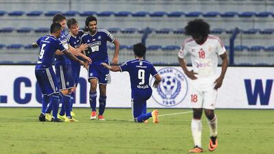 Al Nasr players, including Ivan Trichkovski, second from left, celebrate a job well done against Sharjah. Sarah Dea / The National