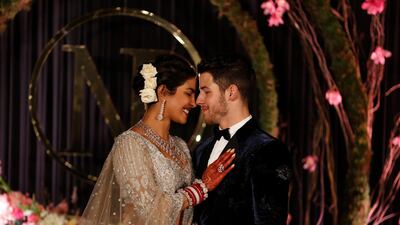 Newlyweds Priyanka Chopra, 36, and Nick Jonas, 26, pose for a photograph during a reception at a hotel in New Delhi on December 4, 2018. Photo: AP