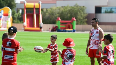 Young boys practice on the side during the West Asia Premiership match at Dubai Police Academy, Dubai.