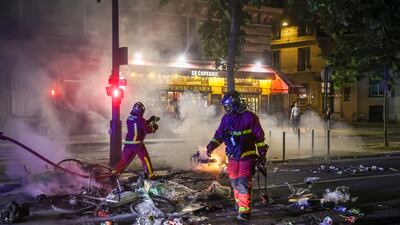 French firefighters extinguish a street fire. EPA