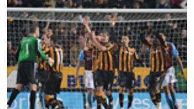 The referee Steve Bennett, not in picture, awards a penalty to Hull after thinking Aston Villa's Ashley Young had handled the ball. After consulting a linesman he changed his decision to a goal kick.