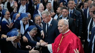 Nuns reach out to Pope Leo as he arrives at the Catholic Basilica of Harissa. AP