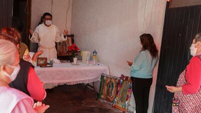 Residents attend a Mass inside a house in honor of the Virgin of Guadalupe, in Mexico City. AP