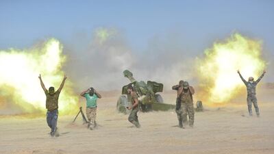 Popular Mobilization Forces (PMF) personnel fire artillery rounds. Reuters