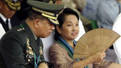 President Gloria Macapagal Arroyo talks to her new chief of staff Lt Gen Delfin Bangit, known to the people as 'the emperor', during the Change of Command ceremony 10 days ago.