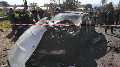 Lebanese soldiers and civil defence workers gather around a destroyed car near the coastal town of Jadra, south Lebanon. AP