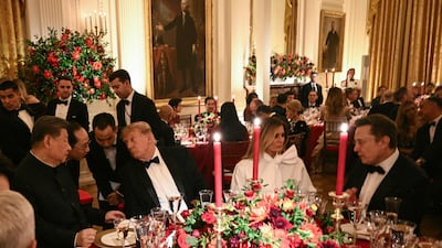 China's President Xi Jinping (L) and US President Donald Trump speak through interpreters as First Lady Melania Trump listens to Tesla CEO Elon Musk during a State Dinner in the East Room of the White House. AFP