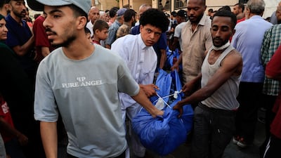 Mourners carry a body through Nuseirat camp in central Gaza on July 29, 2025. Reuters
