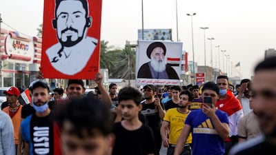 Protesters chant slogans as they march in a demonstration in Iraq's central holy shrine city of Najaf. One person is holding up a picture of Shiite Muslim Grand Ayatollah Ali Sistani. AFP