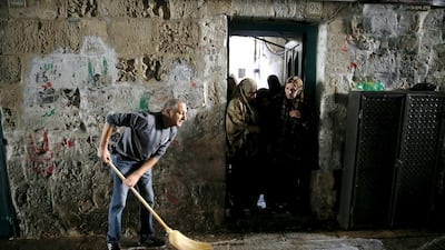 A man cleans blood stains from the floor where an Israeli was wounded in a Palestinian stabbing attack in Jerusalem's Old City October 7, 2015. An 18-year-old Palestinian woman was shot after she stabbed an Israeli near the Al Aqsa compound in Jerusalem in the third knife attack in the city in less than a week. Baz Ratner/Reuters