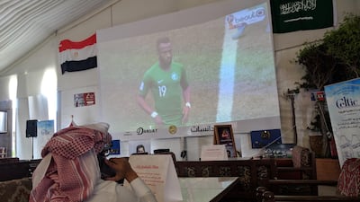 A football fan watches the World Cup group game between Saudi Arabia and Egypt at a cafe in Jeddah. Naser Al Wasmi / The National