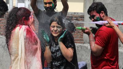 Indian people play with water guns as they celebrate the Holi festival in Jammu, the winter capital of Kashmir, India. EPA
