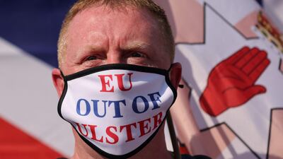 A unionist protester wears a face mask declaring 'EU out of Ulster' in a protest against the Northern Ireland protocol, in central London. AFP